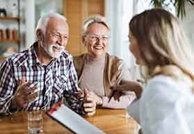Senior couple talking to a receptionist