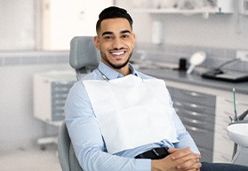 Smiling patient sitting in treatment chair