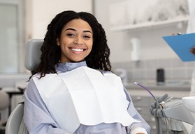Woman smiling while sitting in treatment chair