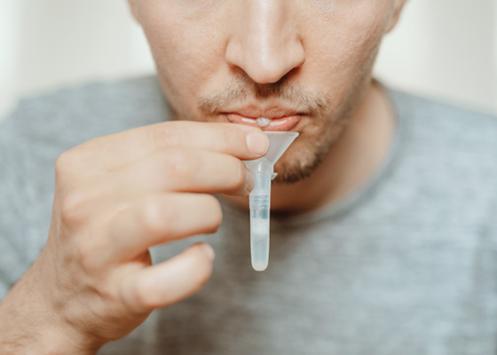 Man providing saliva for test