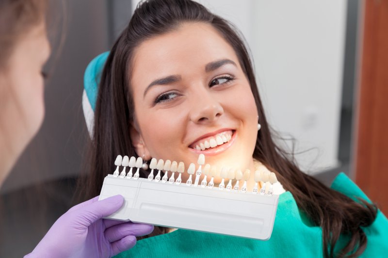 A dentist checking whether a woman is a good candidate for treatment